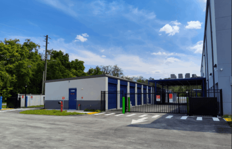 Row of drive-up storage units with a view of the covered loading bay and view of gated exit